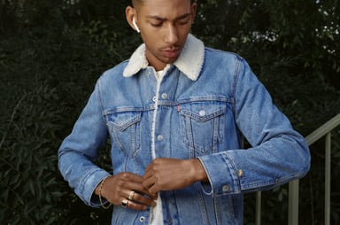 young man wearing levi trucker jacket