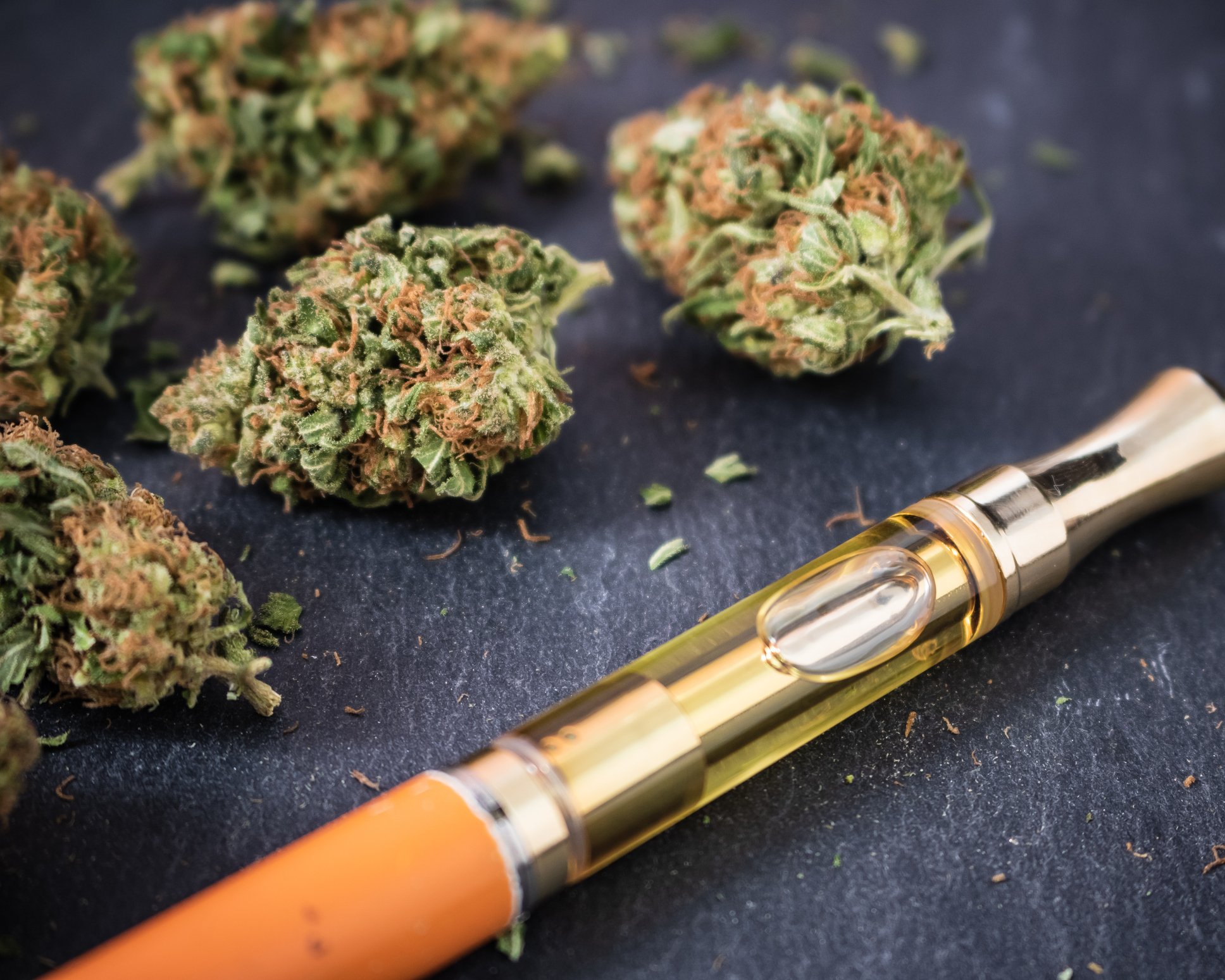 Picture of vaping pen with dried cannabis buds