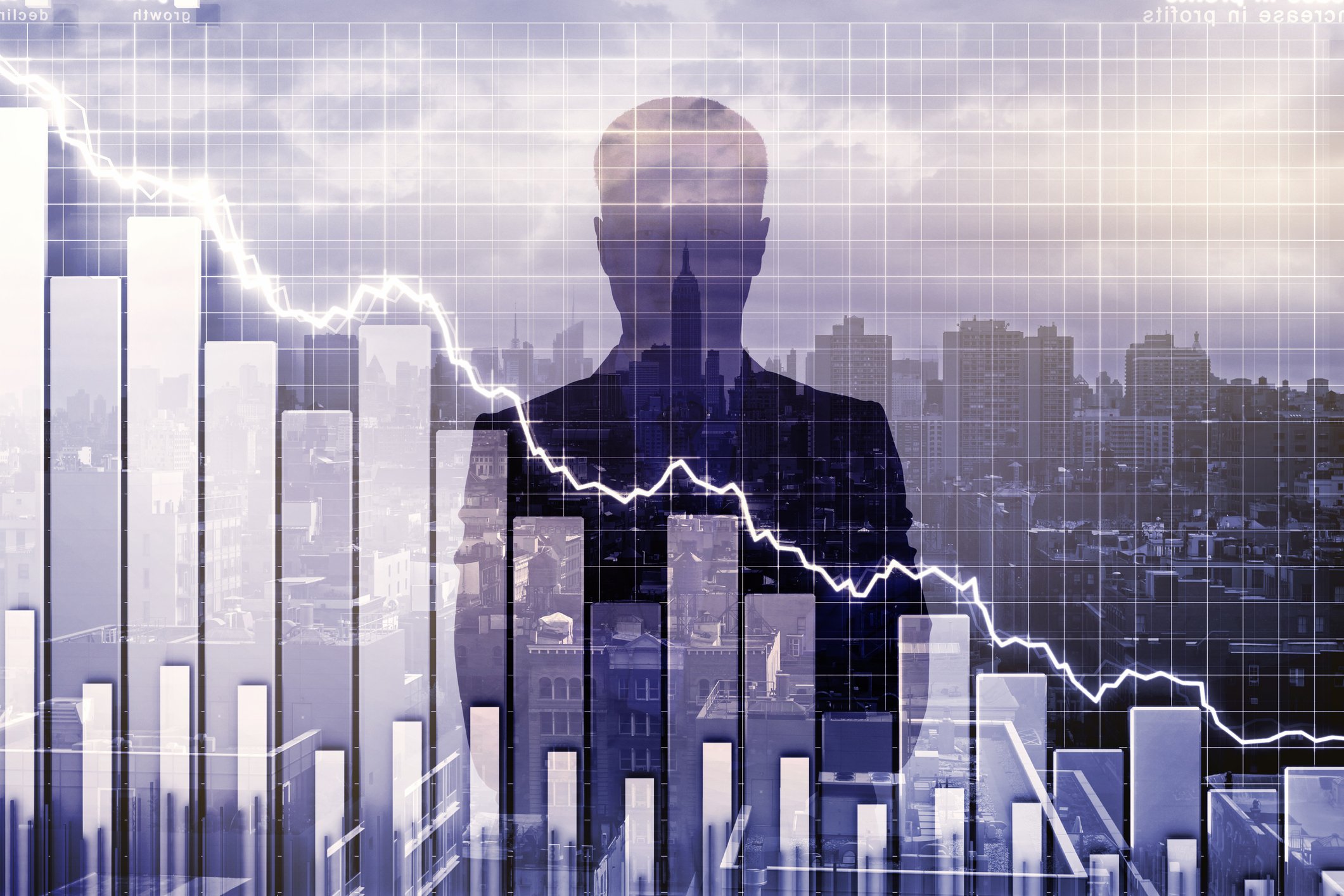 A silhouette of a man looking over a stock chart.