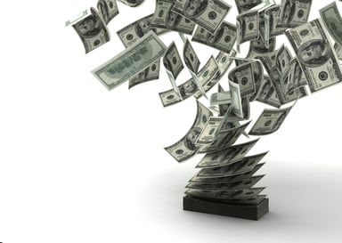 $100 bills being blown away from a stack