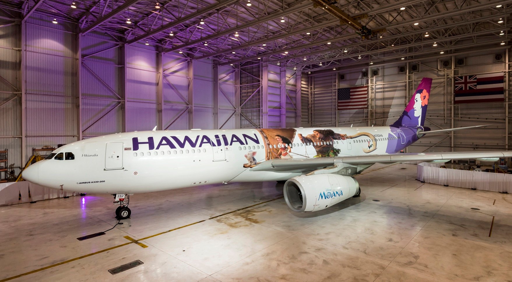 Airplane with Hawaiian Airlines markings in a hangar.