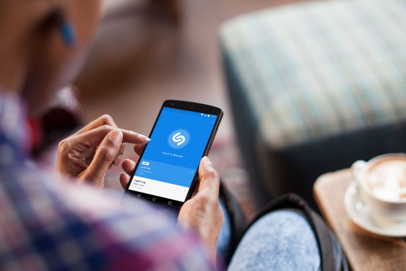 Person using Shazam app on a phone