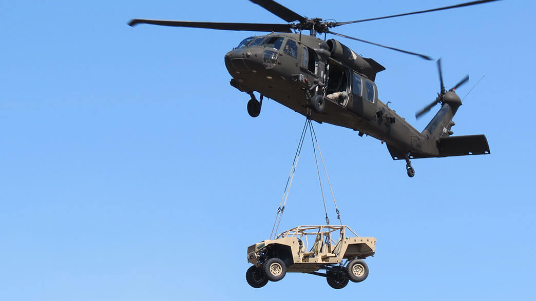 Helicopter carrying a military vehicle
