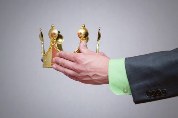 Businessman holding a golden crown