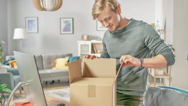 Man opening an online purchase box