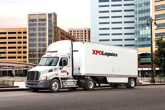 An XPO truck driving in an urban environment.