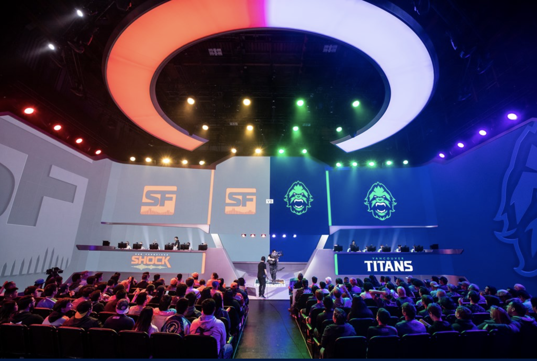 A brightly lit stage at Blizzard arena with a crowd of people waiting for a match to begin.