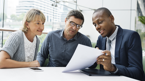 A financial advisor meets with clients.