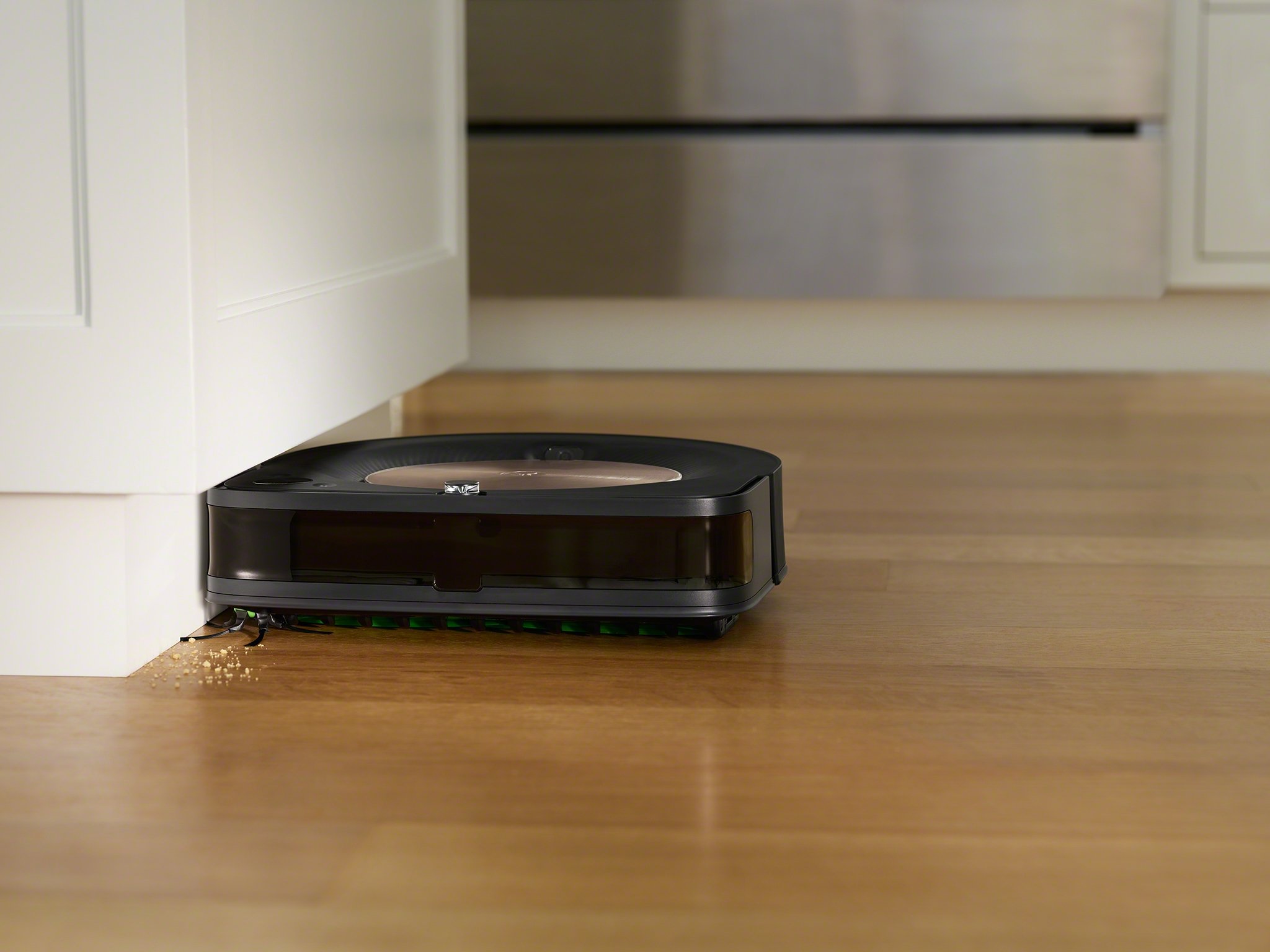 A Roomba vacuum cleaning hardwood floors.