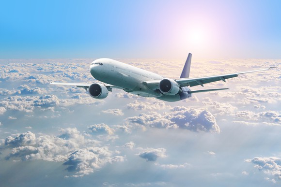 Airplane in flight over clouds.