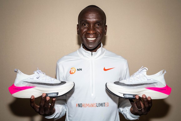 Runner Eliud Kipchoge holds a future version of Nike's NEXT% marathon shoe.