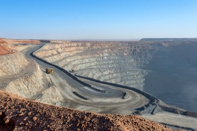 A large mining trunk going into an open pit mine.