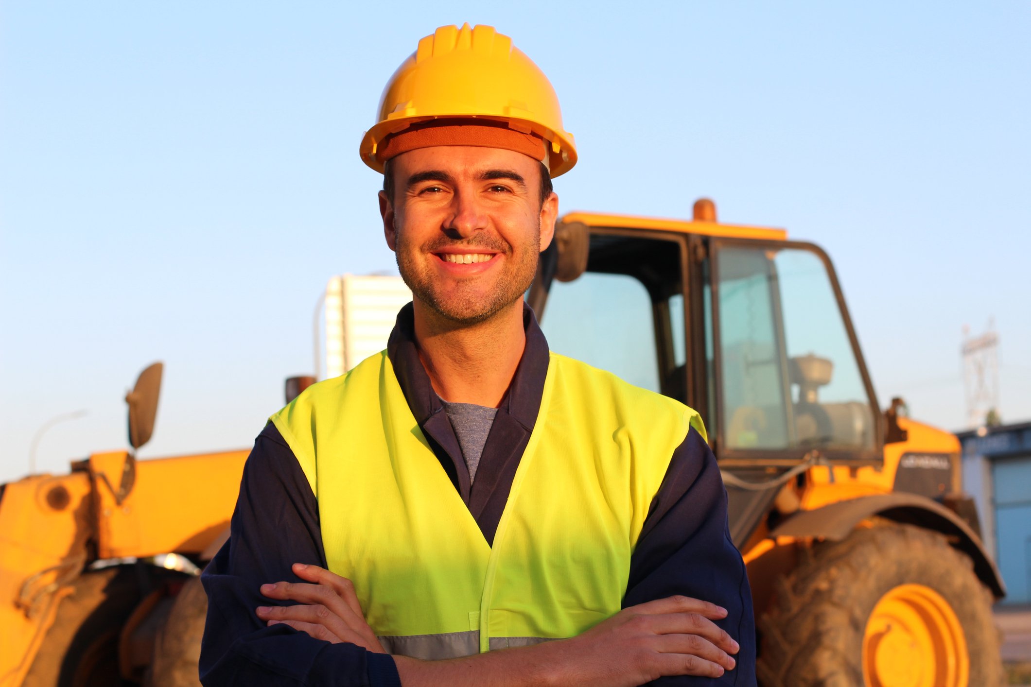 A man in front of a Caterpillar machine. 