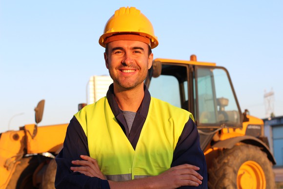 A man in front of a Caterpillar machine. 