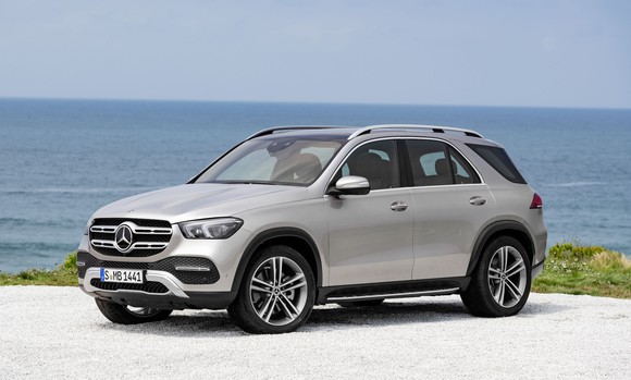A silver 2019 Mercedes-Benz GLE, a five-passenger luxury SUV, parked on a beach.