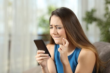 AG girl crossing fingers with smartphone