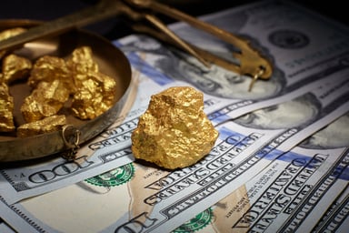 Gold nugets on top of cash.