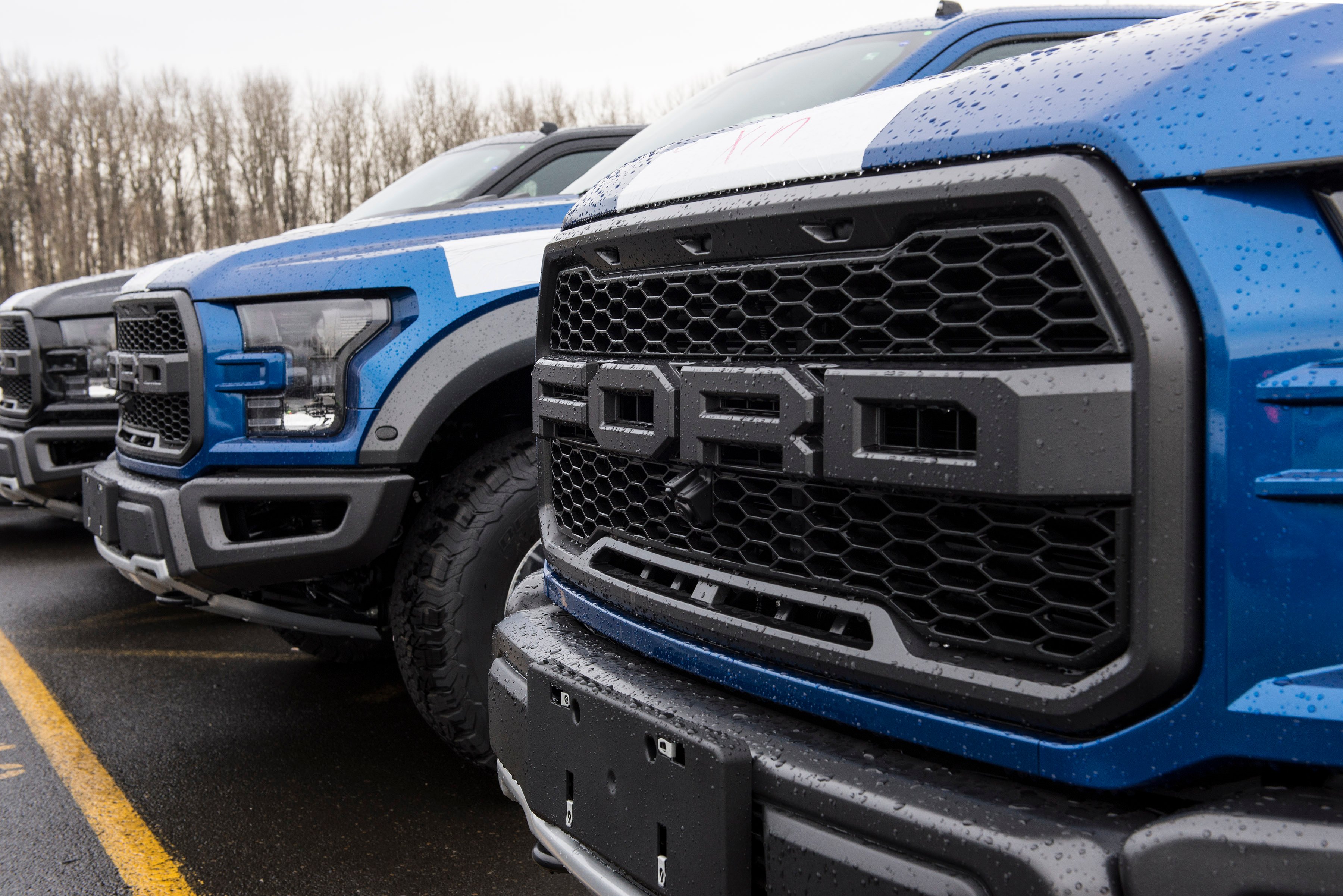Row of Ford F-150 Raptor trucks.