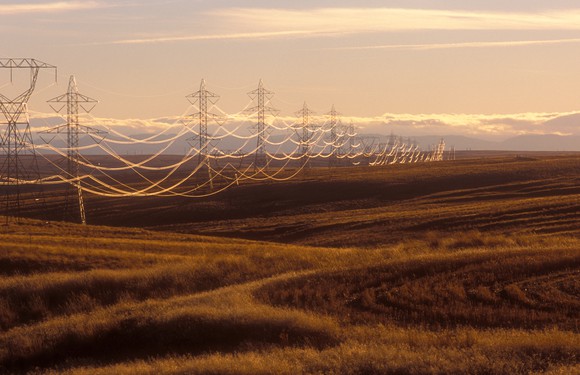 Utility transmission lines across a field.