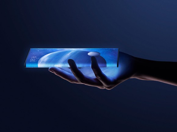 A hand holds a Xiaomi Mi Mix Alpha phone illuminated in blue. 