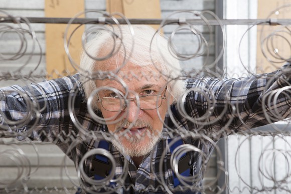 Man looking at a mattress wire frame.