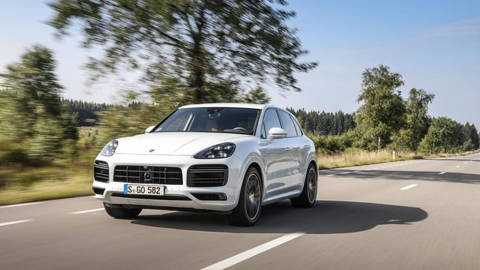 A white Porsche Cayenne, a luxury-sports crossover SUV.