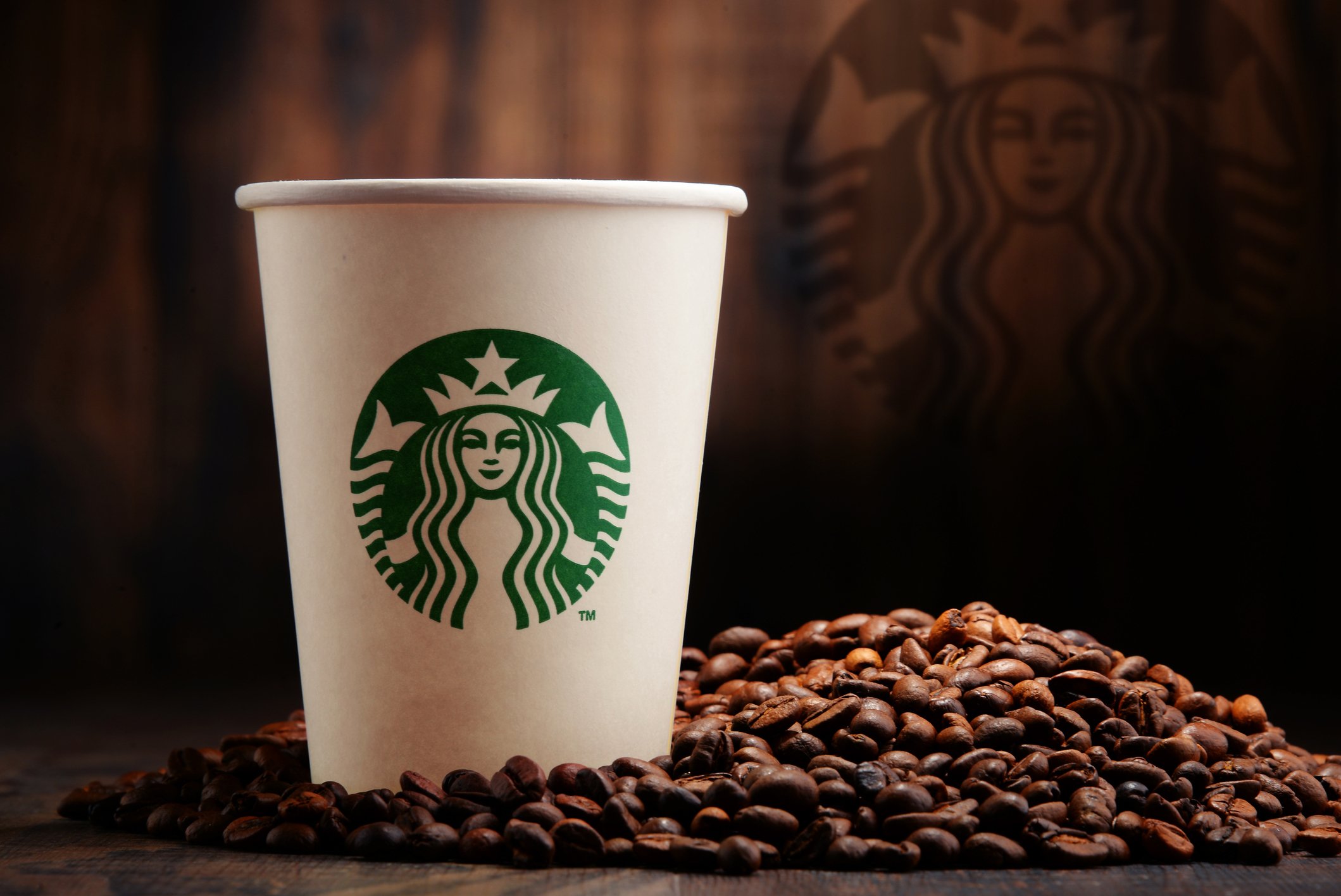 Starbucks coffee cup with coffee beans