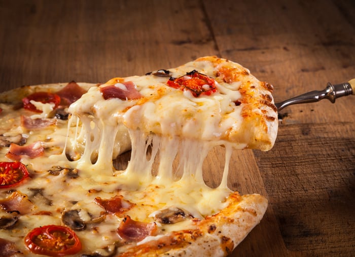 A pizza slice being served.