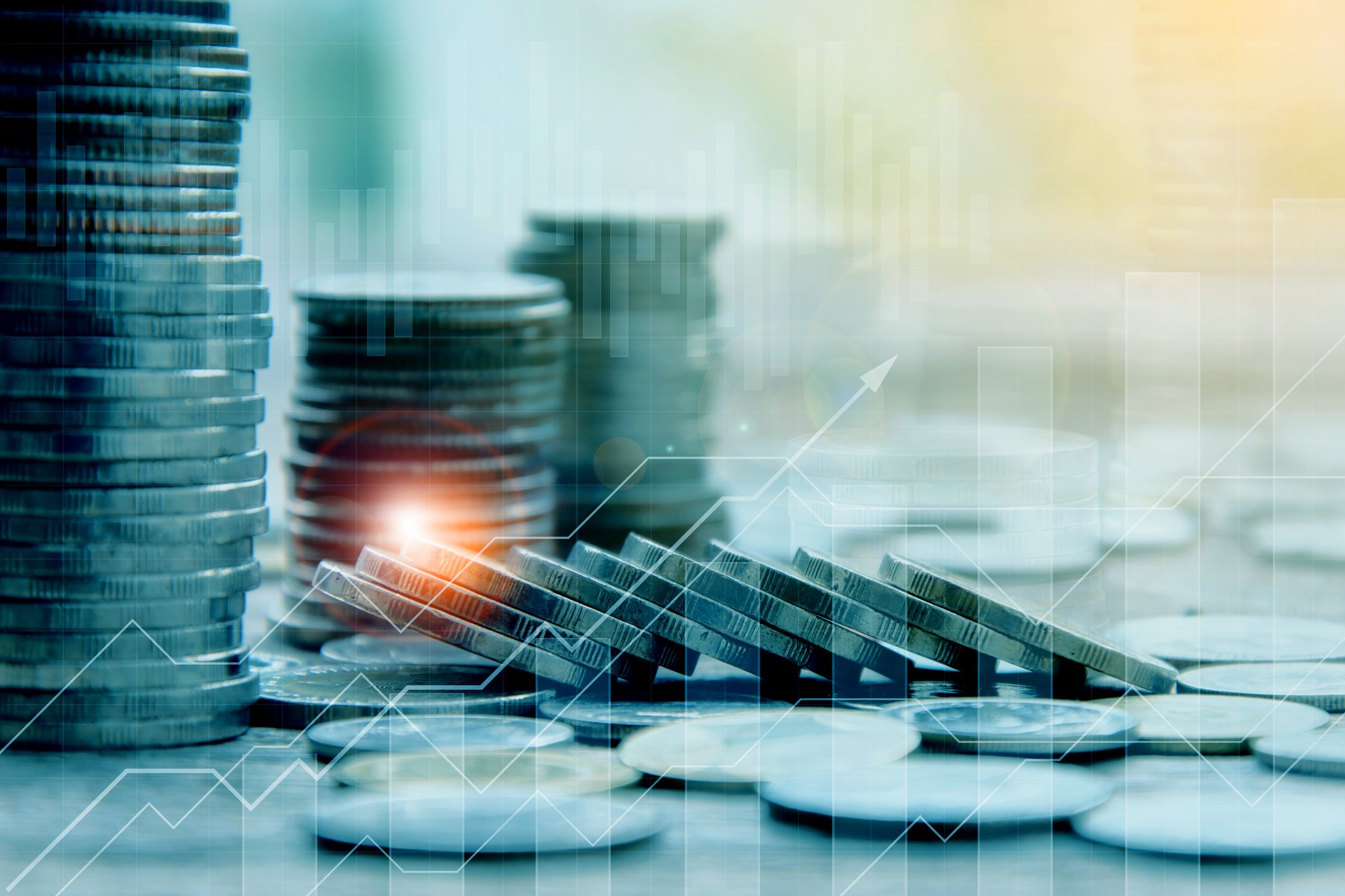 Stacks of coins with arrows rising