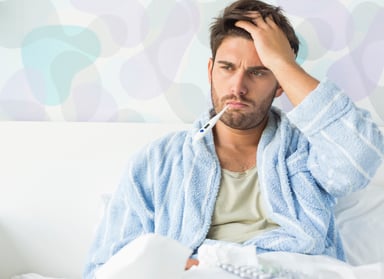 man sick in bed_GettyImages-483229389