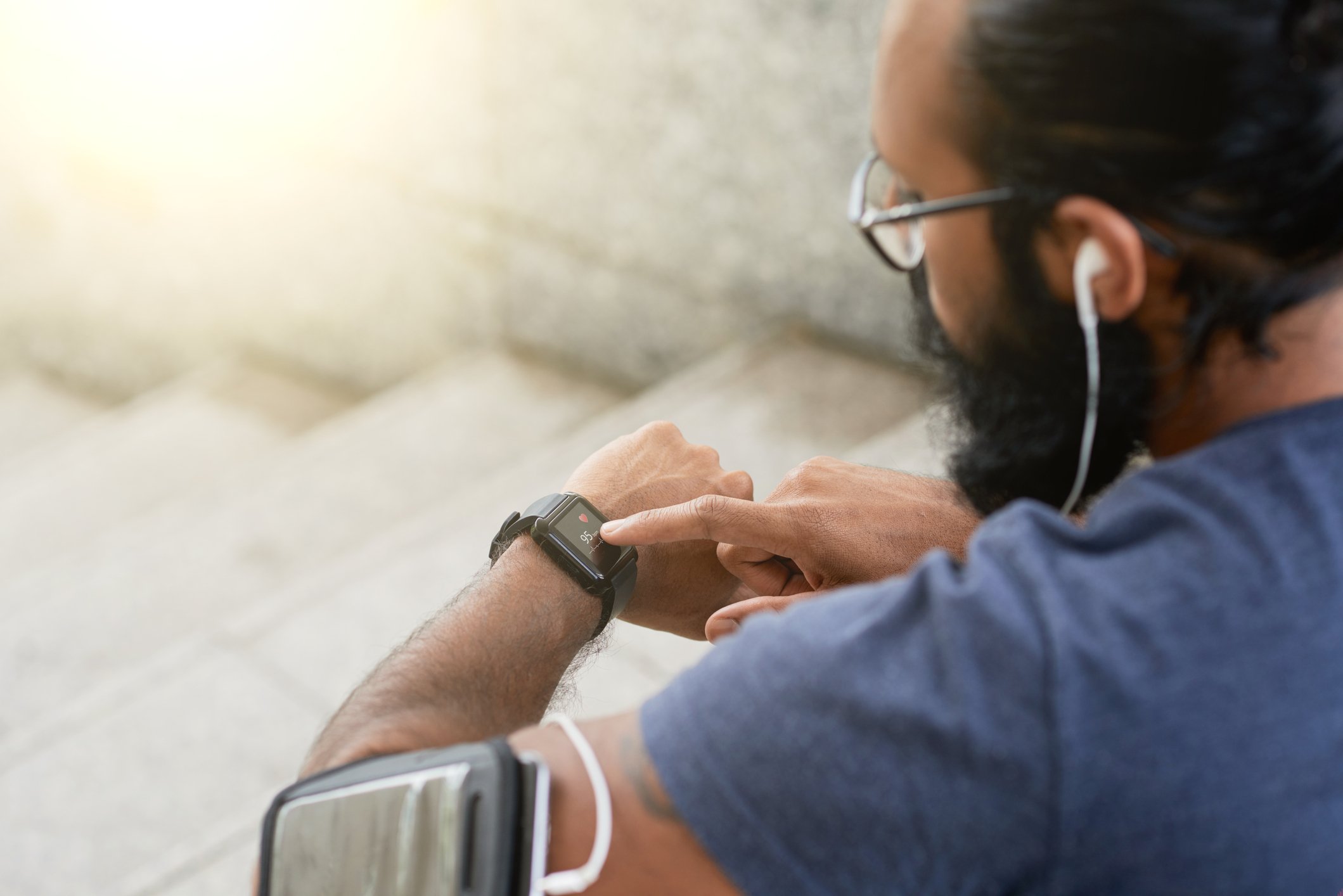 Picture of a man running with a smartwatch or fitness tracker.