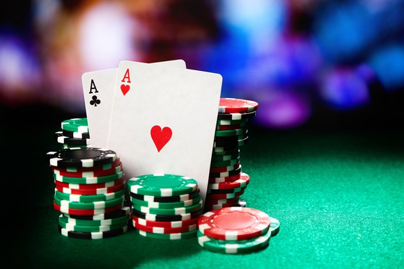 Stacks of poker chips and a pair of aces