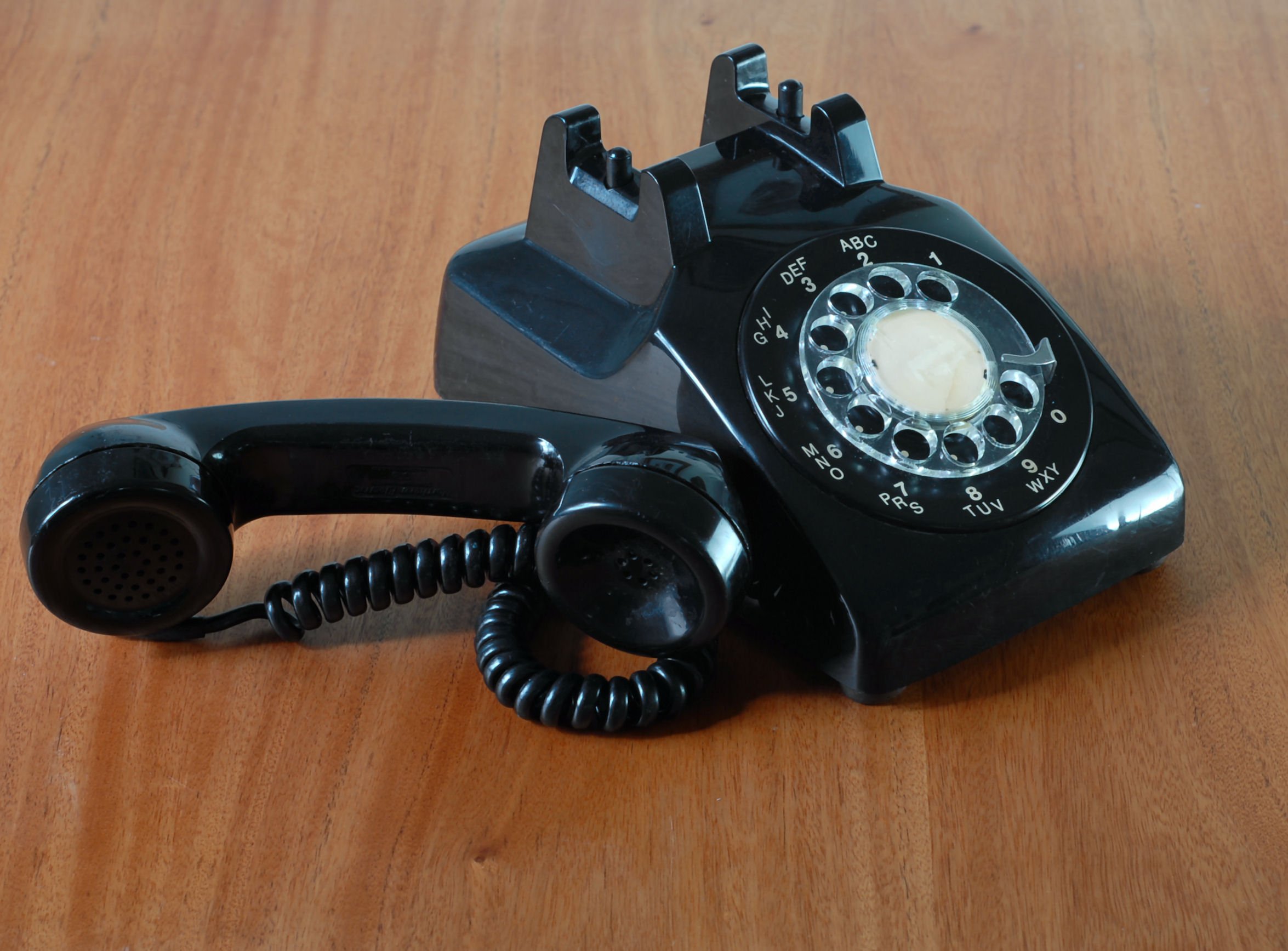 Black rotary dial phone with handset off the hook