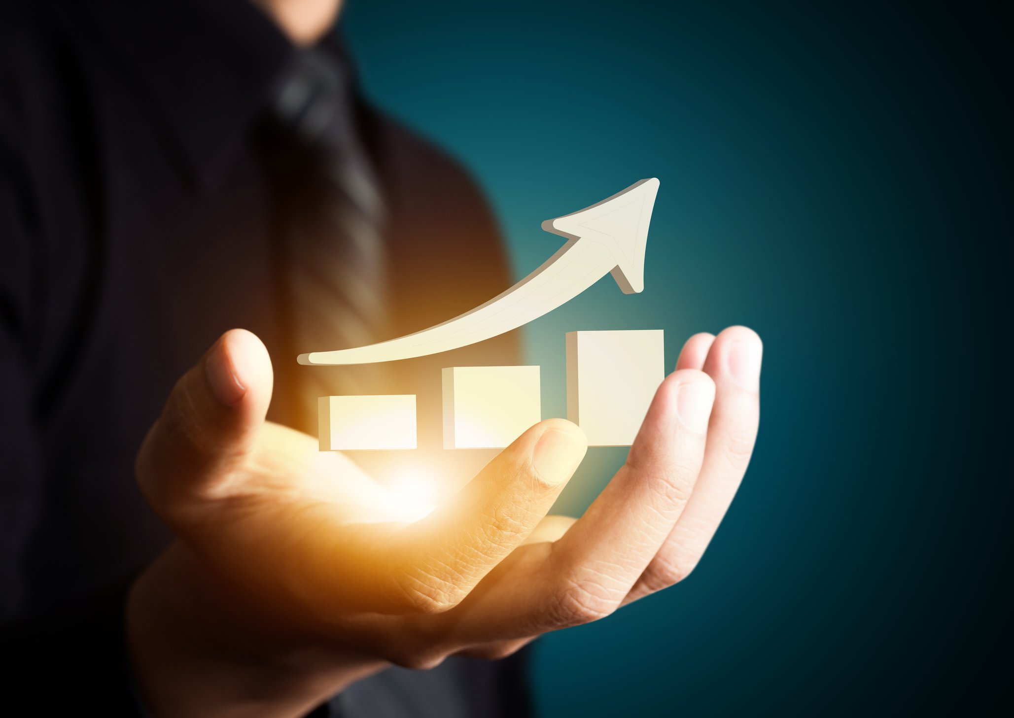 Man holding hand with image of a arrow pointing up and bar chart trending up appearing over his palm