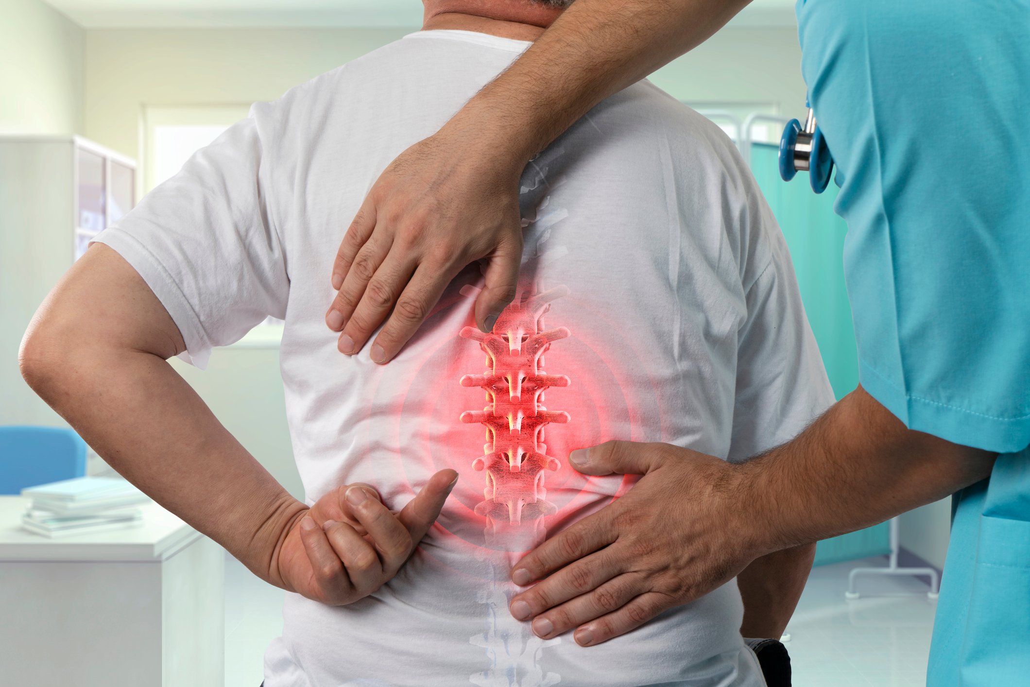 Doctor putting his hands on a man's back with an image of his spine appear on the patient's shirt.