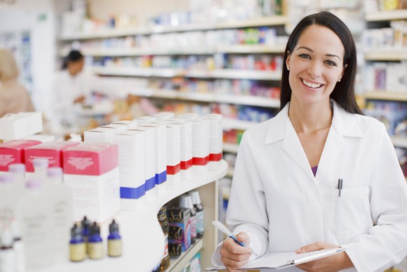 Smiling female pharmacist in a retail pharmacy store