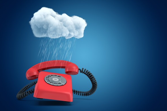 Digital rendering of a red rotary phone under a small cloud that's dropping torrential rain on it.
