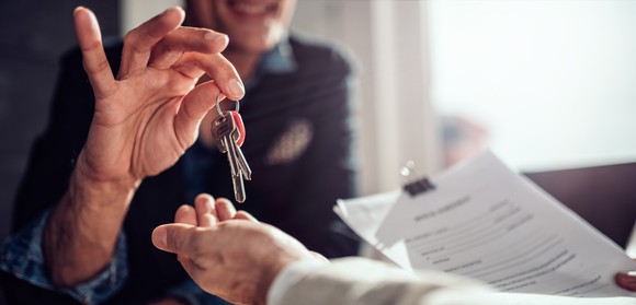 Real estate agent handing keys over