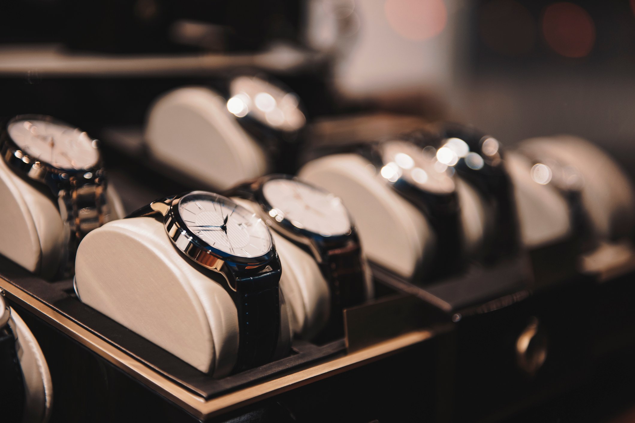 A row of watches in a retail store.