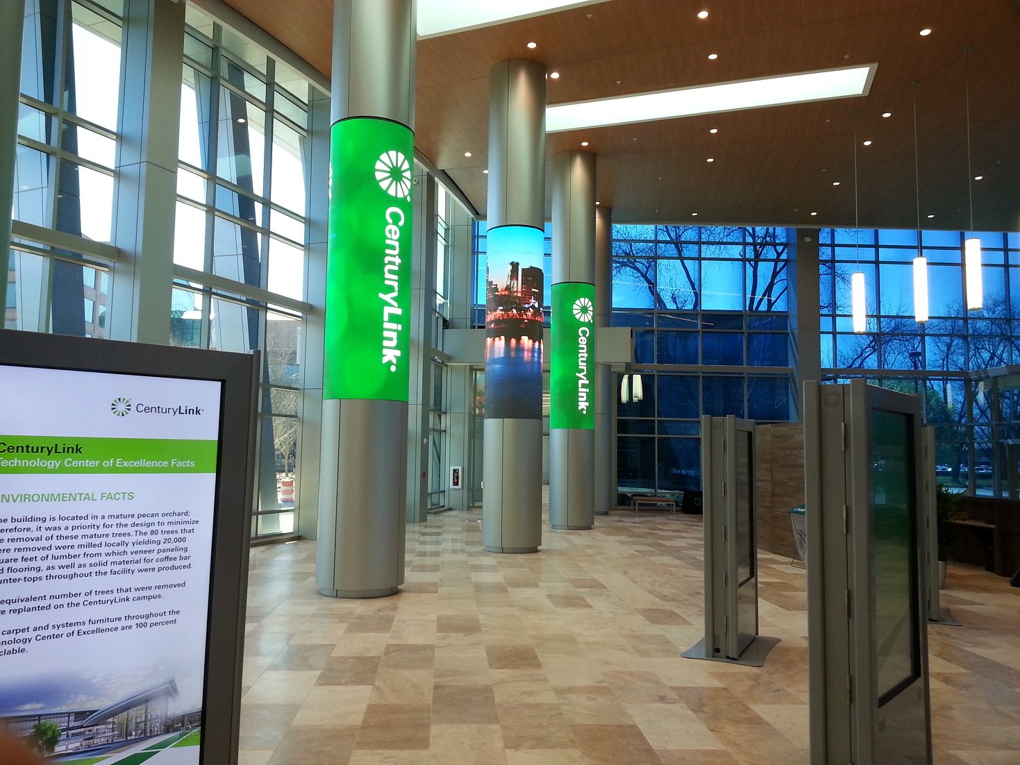 Lobby of office building with CenturyLink banners on several columns.