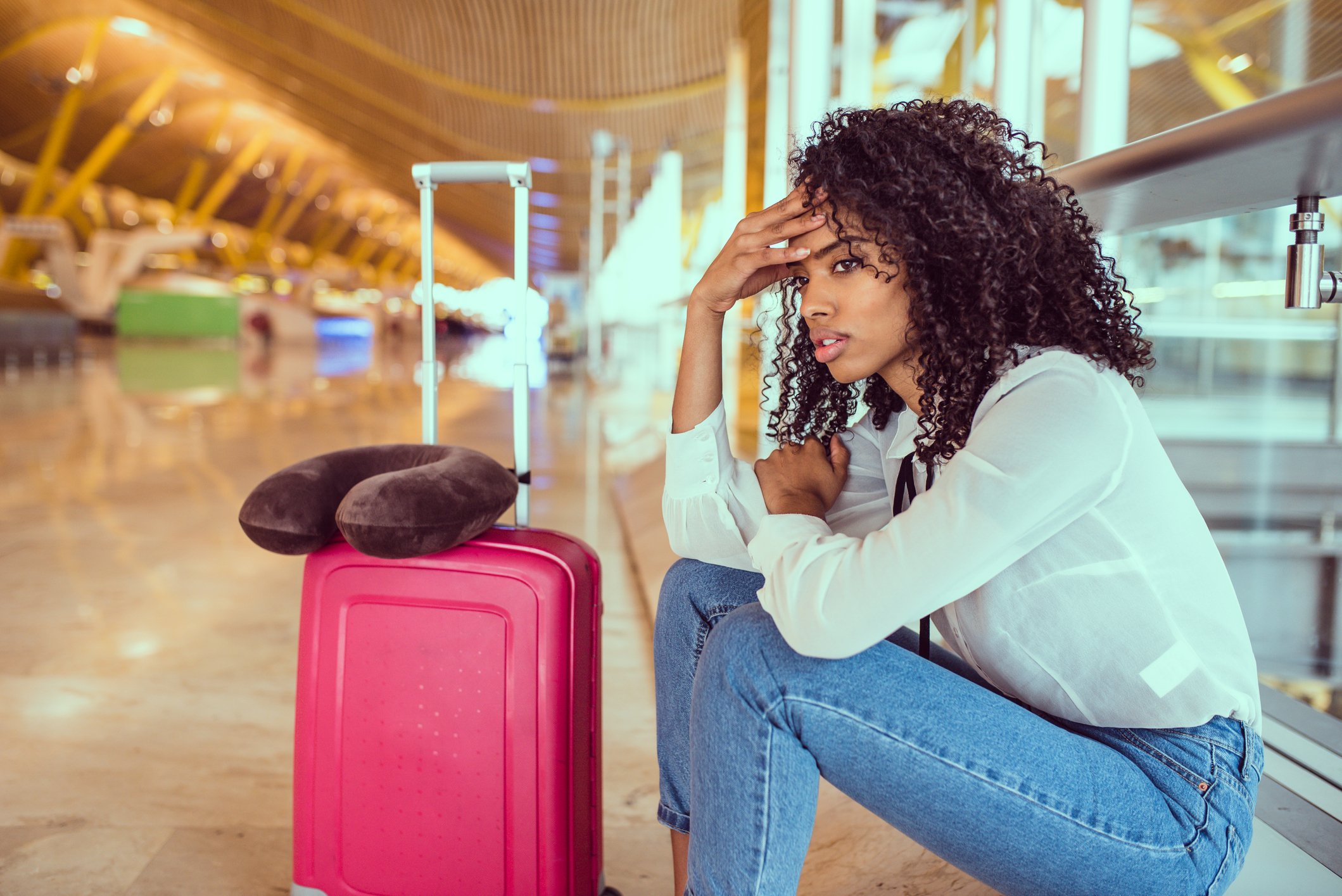 Unhappy young woman at an airport.