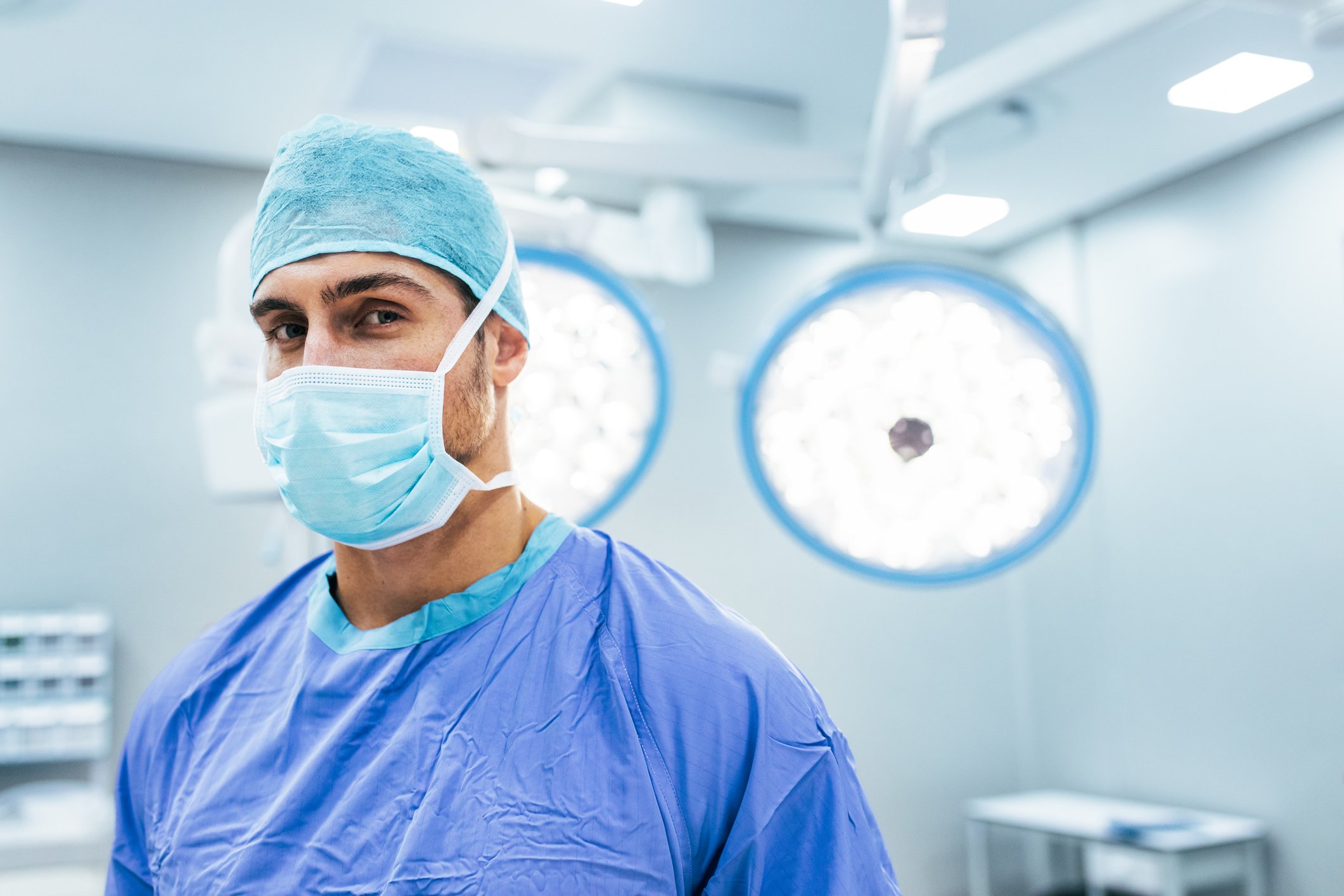 Surgeon with mask on standing in room