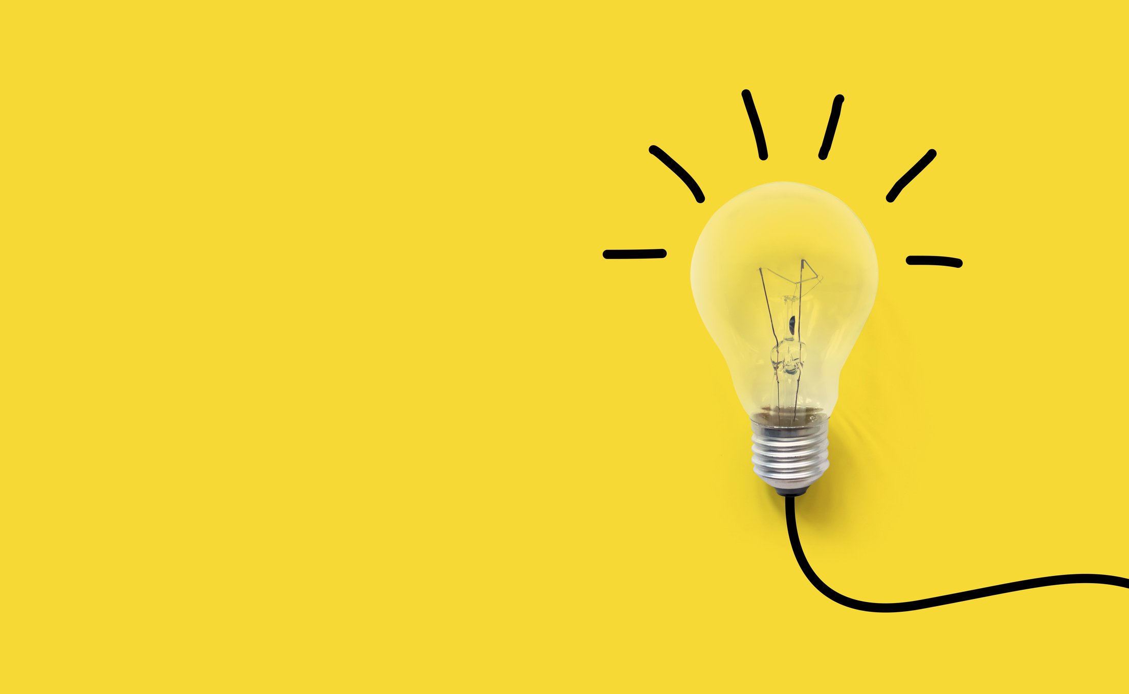 Light bulb on a yellow background with a black wire emitting black lines.