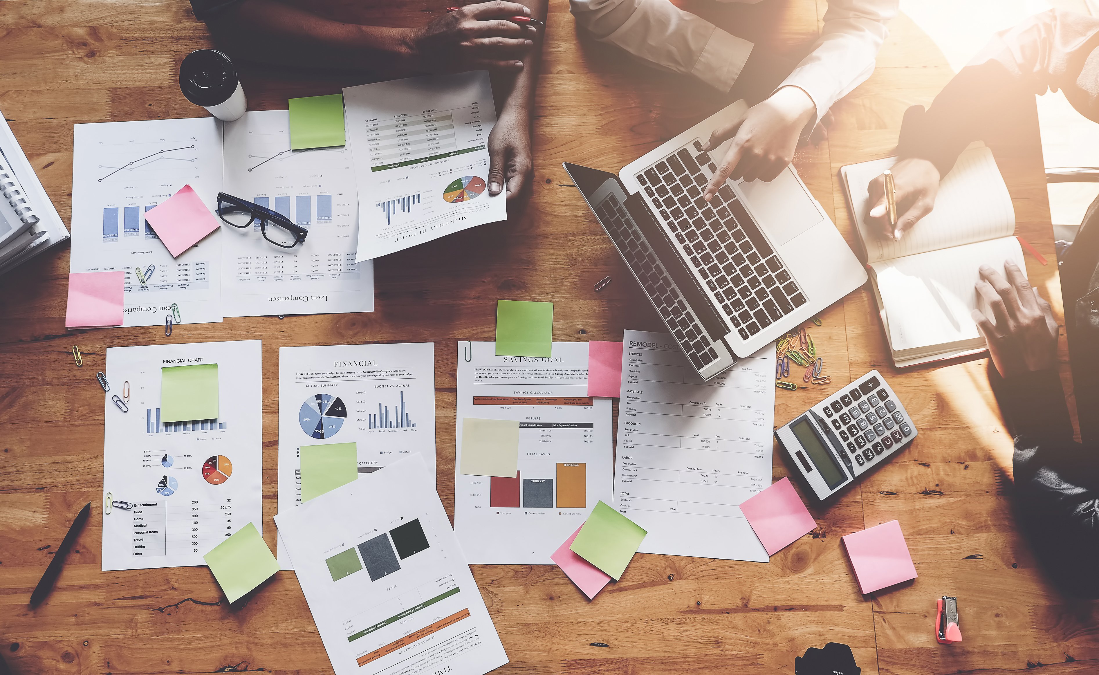 A group of accountants works through a company's finances.