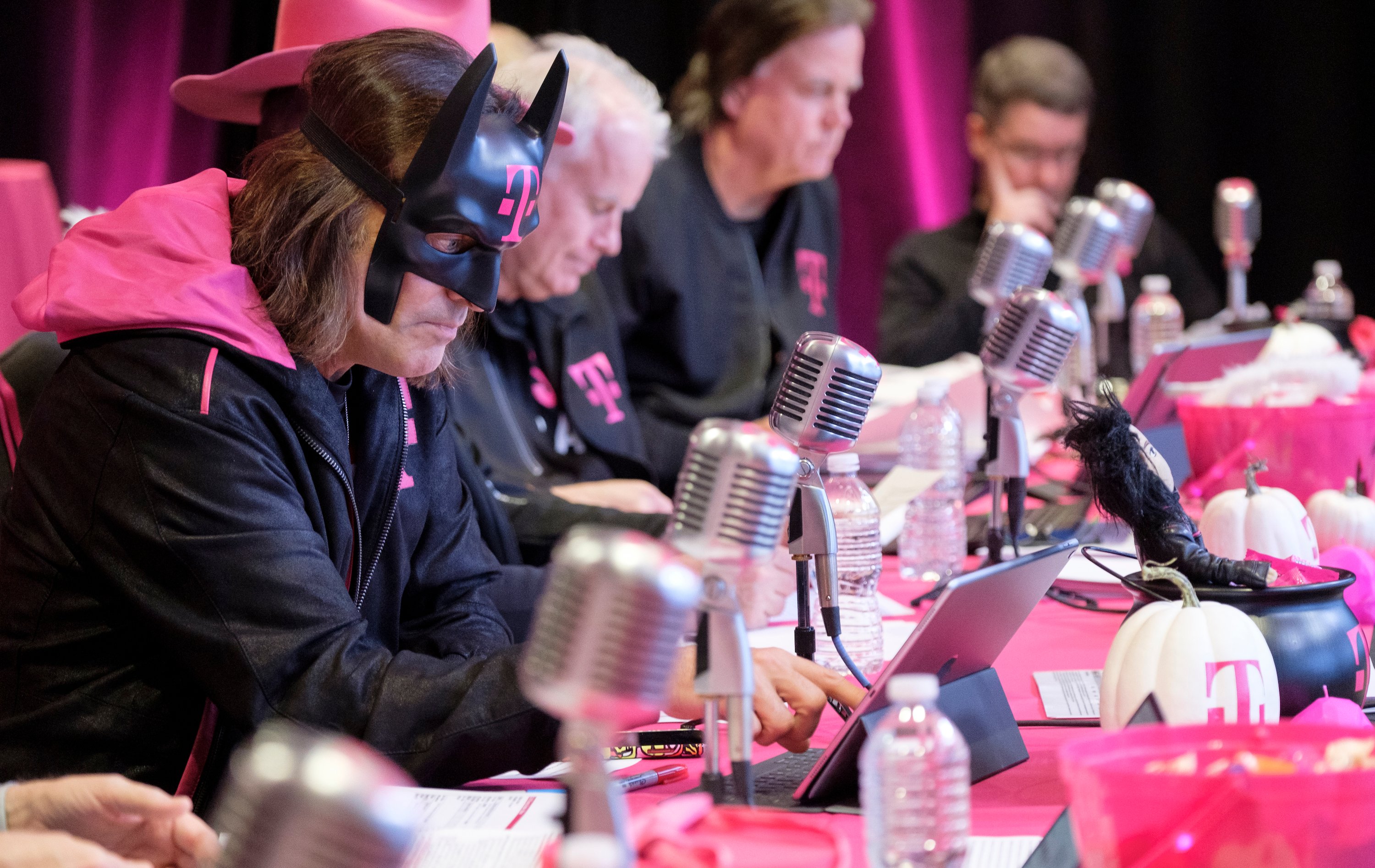 John Legere wearing a Batman mask with the T-Mobile logo during an earnings call