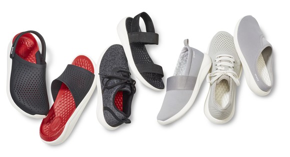 Various Crocs shoes in red, black, and white.