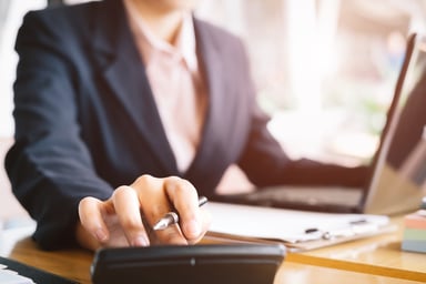 Woman with calculator and laptop