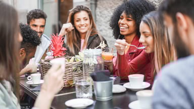 group of happy friends drinking coffee