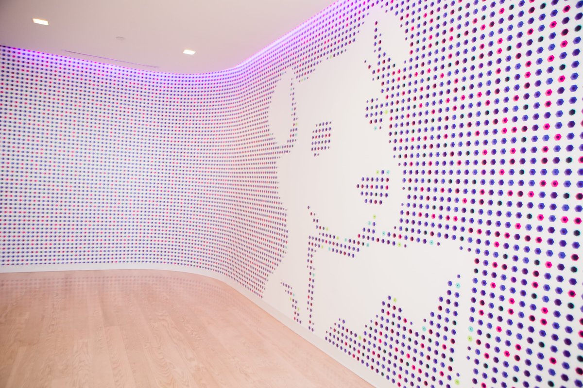 Mosaic wall at Datadog headquarters featuring the company's dog mascot.