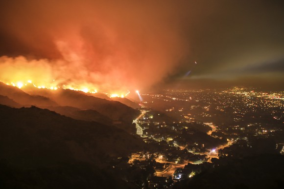 A wildfire around a city at night time